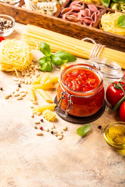 Glazen pot met zelfgemaakte klassieke pikante pasta of pizza tomatensaus. — Stockfoto