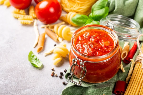 Glass jar with homemade classic spicy tomato pasta or pizza sauce. — Stock Photo, Image