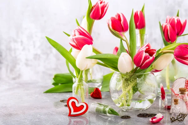 Pink and white tulips in glass vases — Stock Photo, Image