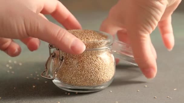 White raw quinoa in glass jar — Stock Video