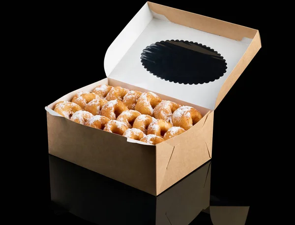 新鲜出炉的油炸圈饼包装在纸盒上黑色 — 图库照片