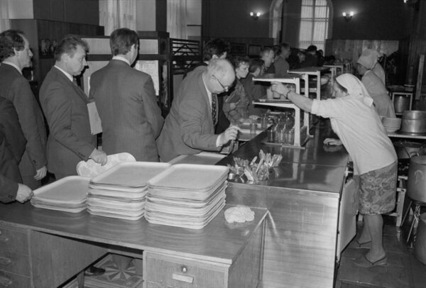 Moscow, USSR - November 23, 1989: Canteen in the Ministry of the Automotive Industry of the USSR. Employees queue to get meals. Canteen workers serve food.