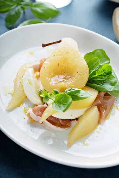 Poached pear with fresh cheese and proscuitto — Stock Photo, Image