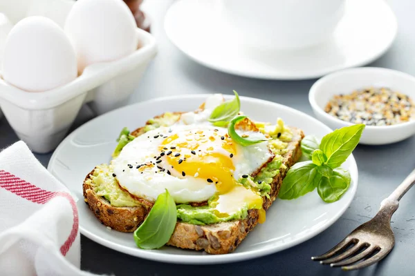 Avocado toast with fried egg — Stock Photo, Image