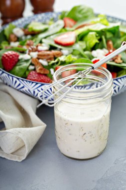 Homemade ranch dressing in a glass jar clipart