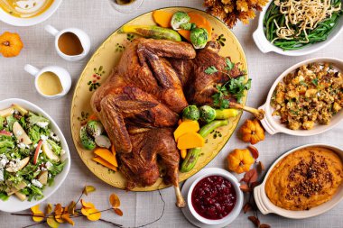 Traditional Thanksgiving table with turkey and sides clipart