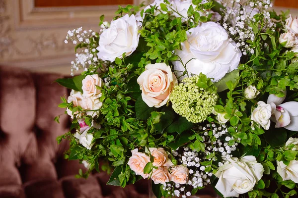 Bouquet of white roses on marble table in interior of the Baroque style