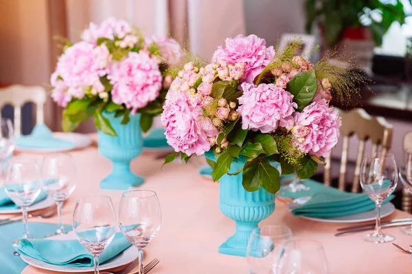 Beautiful bright bouquet of peony on the wedding table in vase