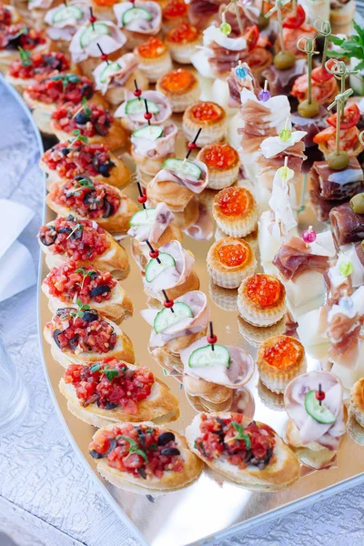 Banquete de catering bellamente decorado con diferentes aperitivos —  Fotos de Stock