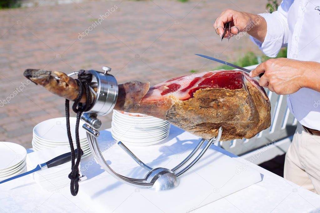 Spanish Iberian ham or Pata Negra mounted on a wooden stand with