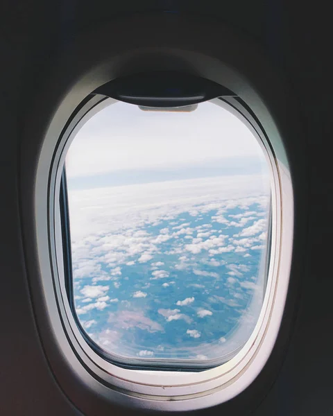 Plane window view with blue sky and clouds. — Stock Photo, Image