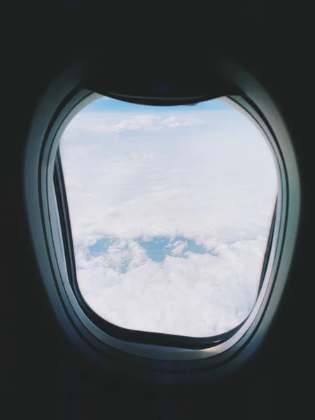 Plane window view with blue sky and clouds. — Stock Photo, Image