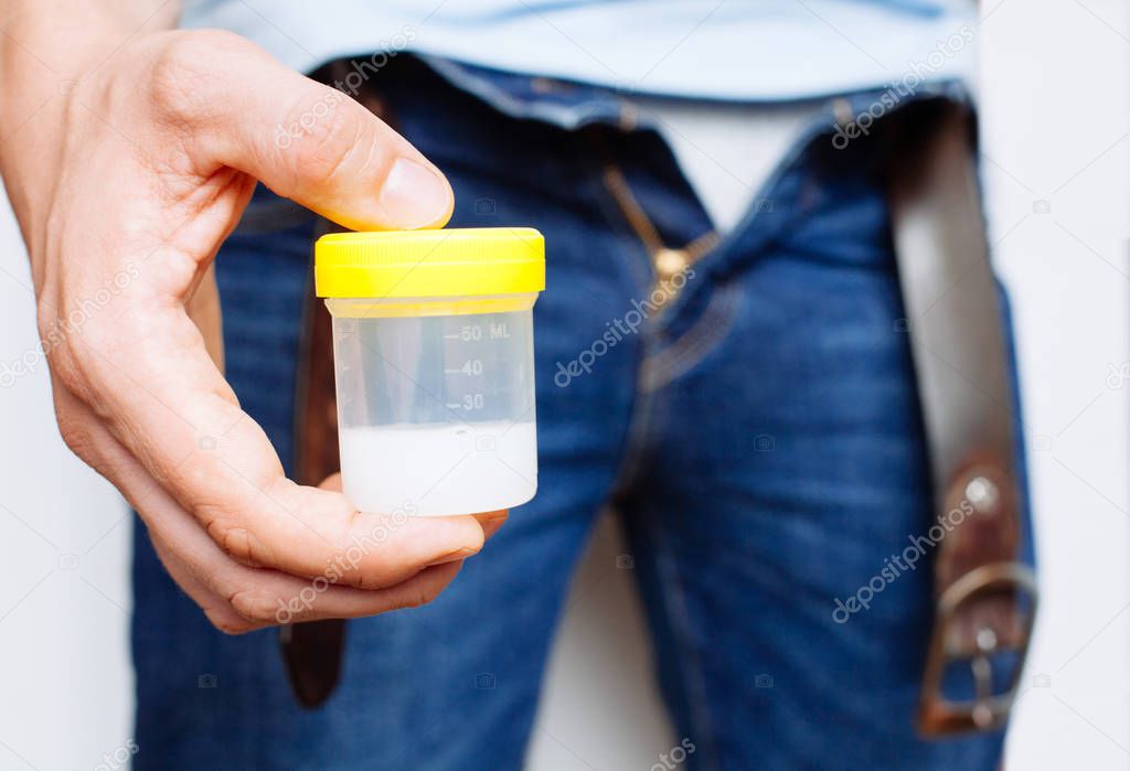 Man Holding in Hands Container With Sperm