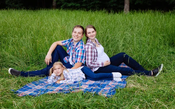 Happy family enjoying picnic in nature — Stock Photo, Image