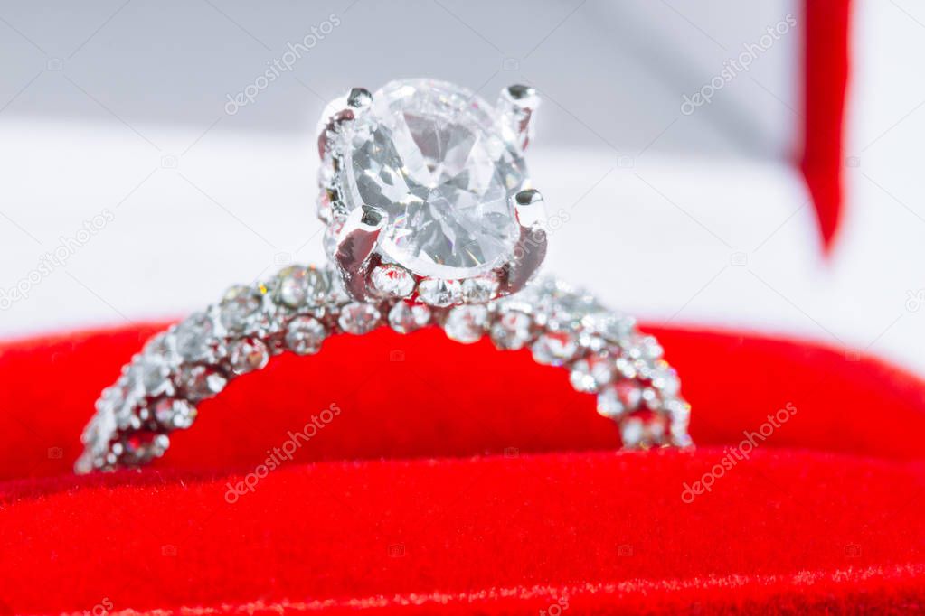 Diamond engagement ring in red box on white background