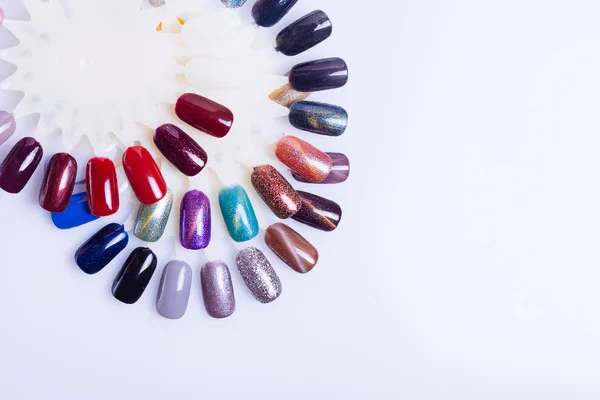 Palette of nail polish for manicure on white background