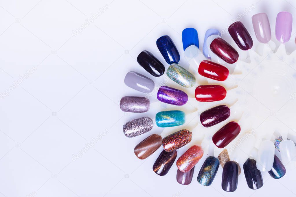 Palette of nail polish for manicure on white background