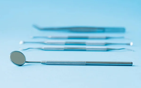 Outils de dentiste sur fond bleu : Hygiène dentaire et santé — Photo