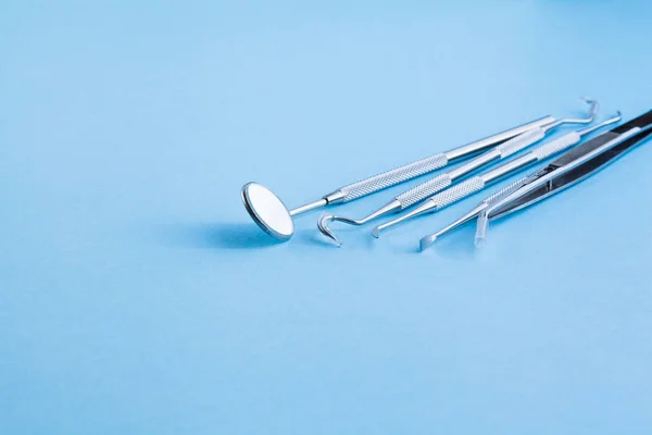 Tandläkare verktyg på blå bakgrund: tandhygien och hälsa Stockbild