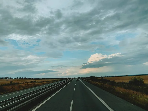 Asphalt road and beautiful nature landscape at sunset