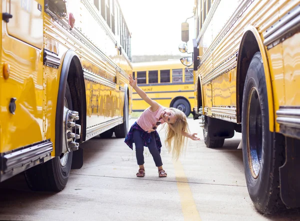 Little girl at school bus Stock Photo