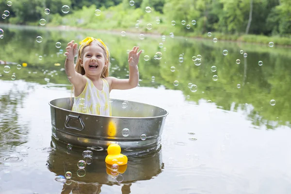 Eccitato bambina godendo sapone sud al lago — Foto Stock