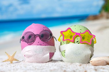 Plajda yüzleri maskeli Paskalya yumurtaları