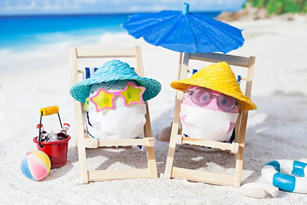 Easter eggs with faces mask at beach