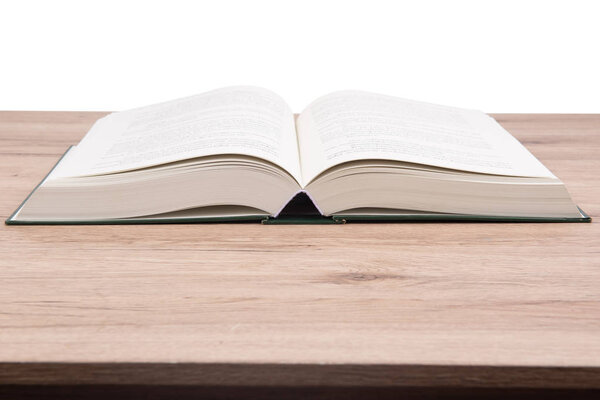 Open book on wooden table on isolated background.