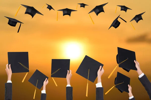 Graduation Holds Black Hat Yellow Tassel Sunset Background — Stock Photo, Image