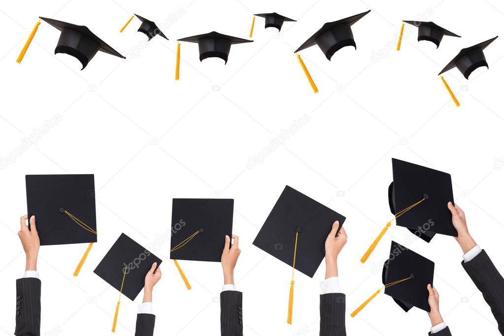 Graduation holds a black hat and a yellow tassel on white isolated background.