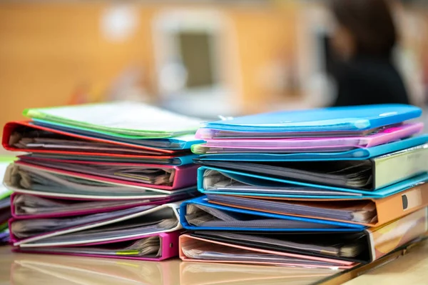 Colorful document files overlaid on the office desk