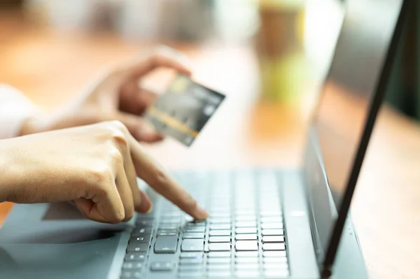 close up Woman in cafe shopping online with laptop