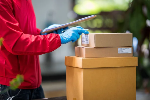 Close Delivery Man Noszenie Niebieskich Rękawiczek Czerwonej Tkaninie Sprawdzanie Pudełek — Zdjęcie stockowe