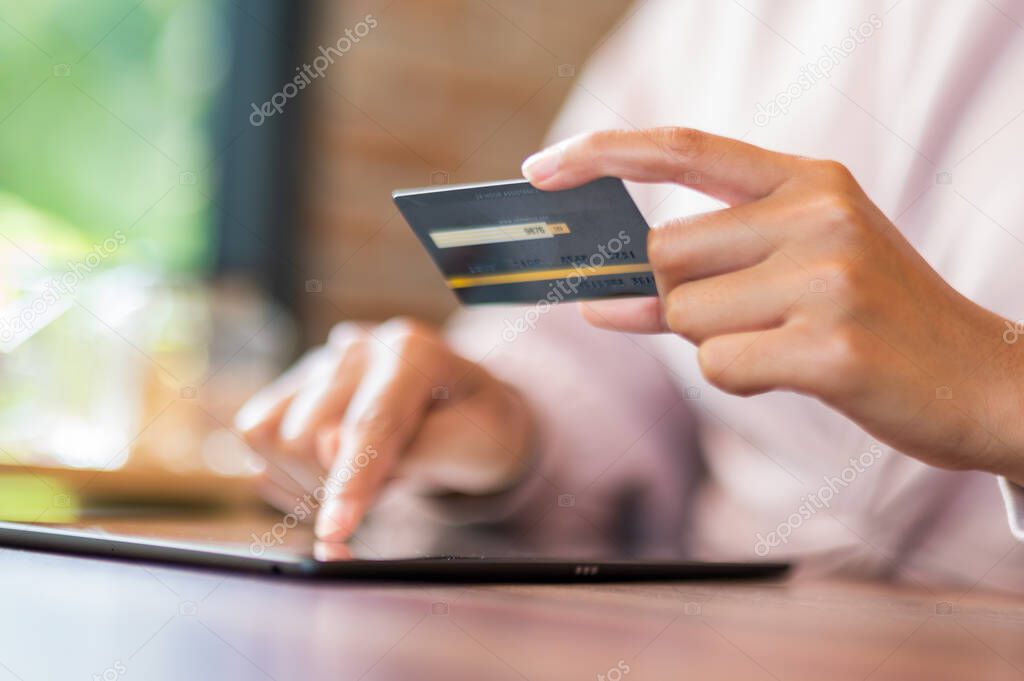 close up Woman in cafe shopping online with laptop