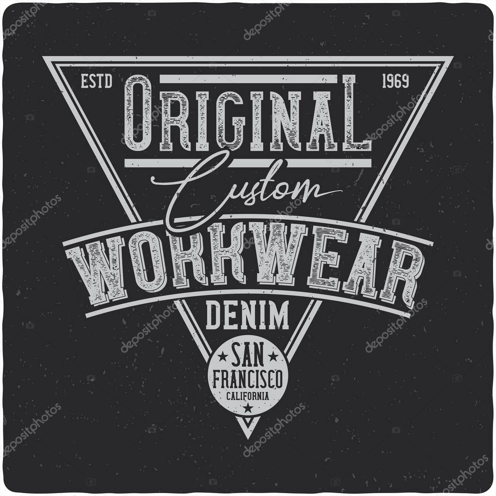 Denim vintage label logo with lettering composition on dark background.