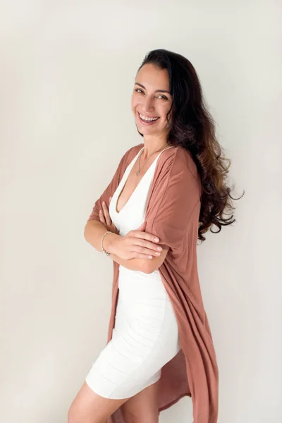 Brunette woman standing and laughing