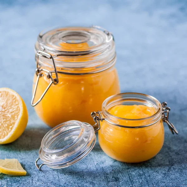 Lemon Curd in Jars over Blue Background — Stock Photo, Image