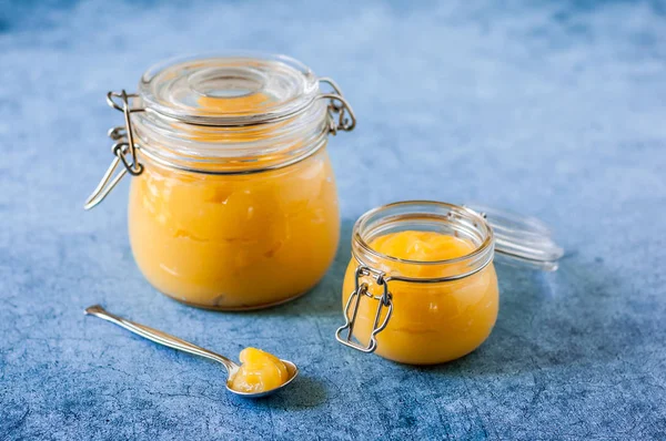 Lemon Curd in Jars over Blue Background — Stock Photo, Image