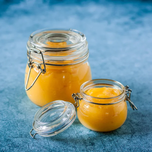 Lemon Curd in Jars over Blue Background — Stock Photo, Image