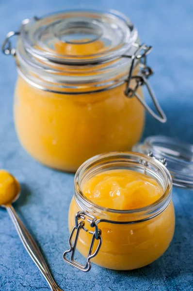 Lemon Curd in Jars over Blue Background — Stock Photo, Image