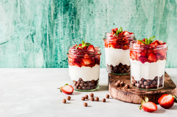 Greek Yoghurt with Strawberries, Honey  and Cereal in Jars, copy space for your text