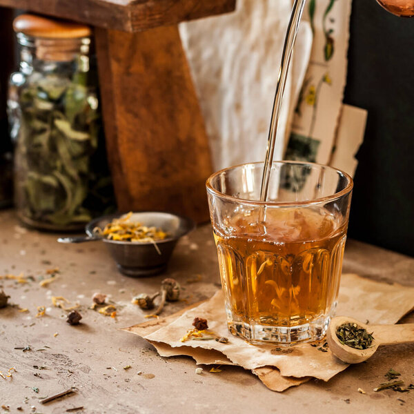 Pouring Herbal Tea into a Glass, Variety of Dried Herb Mixes, square