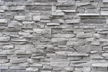 düzensiz dokulu gri dekoratif tuğla yüzeyi temsil eden modern mimari detay