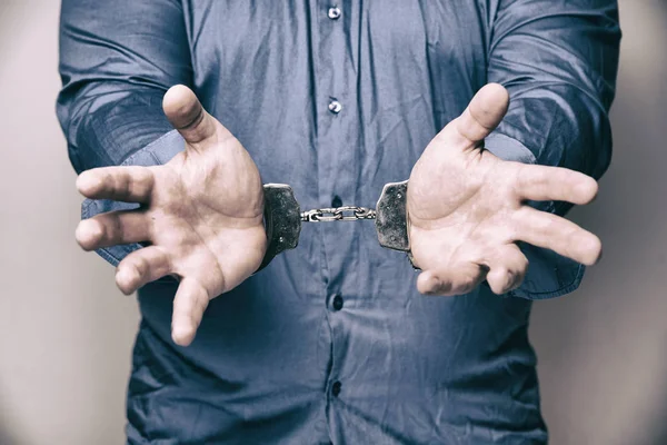 imprisoned man with handcuffs on his hands