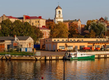 Vyborg, Rusya - 26 Eylül 2020. Güzel bir sonbahar şehri batan güneşin ışınları altında. Saat Kulesi ve eski tarihi evler.