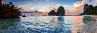 Popular travel tropical karst rocks perfect for climbing Phra Nang Cave Beach in sunset, Krabi province, Thailand clipart