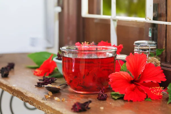 Red karkade hibiscus red sorrel tea in glass mug with dry tea cu — Stock Photo, Image