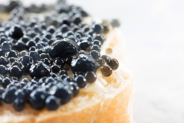 Expensive delicious black caviar white bread sandwich snack on w — Stock Photo, Image