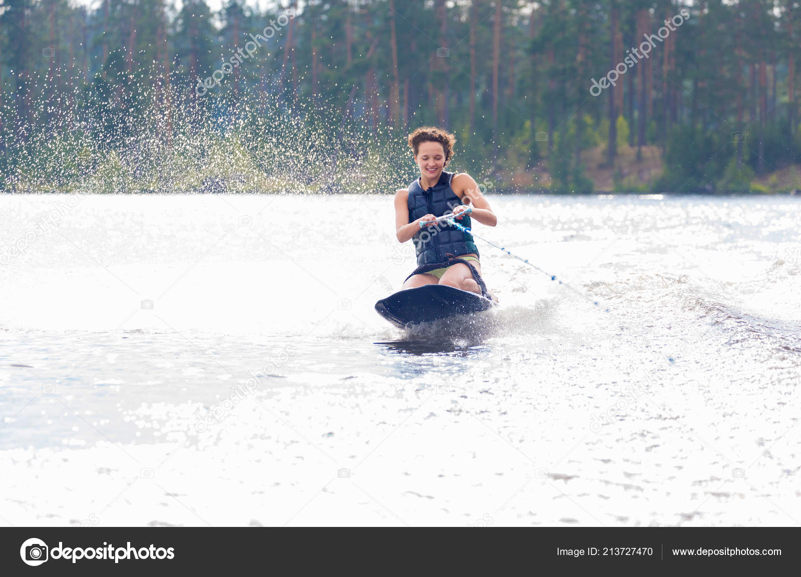 Young Athletic Woman Riding Kneeboard Lake Stock Photo by ©annamoskvina